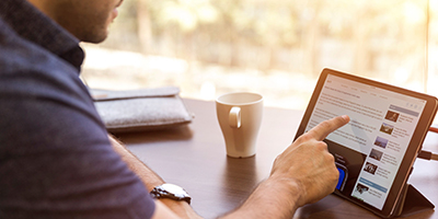 negative-space-man-browsing-tablet-ipad-computer-coffee-touch-finger-work-desk-office-linkedin-400