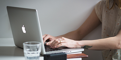 negative-space-woman-working-laptop-400